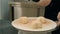 Woman confectioner sprinkles cakes standing at table in cafe kitchen.