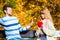 Woman confess love to man on bench in park.