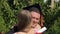 Woman congratulating graduate boyfriend and embracing him, happy moment