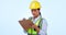 Woman, construction and checklist to write in studio, maintenance and inspection in safety gear. Asian person, engineer