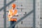 A woman in a construction uniform is studying a project