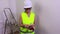 Woman construction worker counting money and shows thumb down