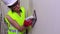 Woman construction worker grind the wall