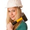 Woman with constructor helmet and hammer happy to do tough work.