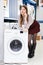 Woman consulted on phone about buying of washer