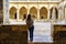 Woman contemplating the Gothic cloister of the Unesco cathedral in the city of Leon, Spain.