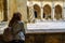 Woman contemplating the Gothic cloister of the Unesco cathedral in the city of Leon, Spain.