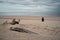 Woman contemplating on sandy beach while looking at the sea - spiritual concept of self-knowledge