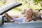 Woman in convertible car smiling