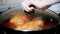 A woman cook chicken in tomato sauce. Hand open pan cover.