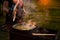 A woman cook opens the lid of a saucepan or cauldron in which pilaf.