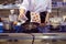 A woman cook pours oil into a frying pan in the kitchen in a cafe