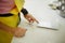 Woman cook power on kitchen scales on table