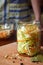 Woman cook sauerkraut or salad on wooden background. Step 5 - Put the cabbage in the jars. Fermented preserved vegetables food.