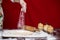 Woman cook sprinkling flour over cutting board