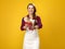 Woman cook on yellow background showing fresh bread