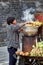 Woman cooking corn clips on a street food stall in Qufu, China