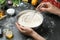 Woman cooking delicious gyoza at black table, closeup