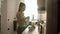 Woman cooking flakes with milk for breakfast at light kitchen