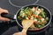 Woman cooking frozen vegetable mix on induction stove