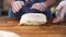 Woman in cooking gloves cutting puff pastry with raisins into pieces, food concept. Stock footage. Close up for hands