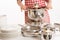 Woman cooking, holding kitchen utensils and pot