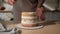 Woman is cooking homemade cake. Pastry chef collects cake from biscuit layers, cake preparation. cooking, baking and