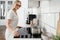 Woman cooking with induction stove at home kitchen