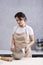 Woman is cooking in kitchen with bowl in her hands. Vertical frame