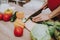 Woman is Cooking Salad from Fresh Vegetables