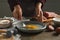 Woman cooking schnitzel at wooden table indoors