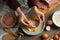 Woman cooking schnitzel at wooden table, top view