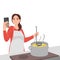woman cooking soup at kitchen with online recipe on cellphone. Smiling modern mother preparing food using cookbook or application