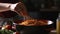 Woman cooking tasty pasta bolognese in kitchen, closeup