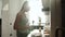 Woman Cooking Toast With Butter For Breakfast On Modern Kitchen