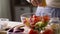 Woman cooking vegetable salad with lemon at home