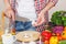 Woman cooks on the kitchen, soft focus background