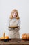 Woman cooks pumpkin pie on white background