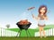 Woman cooks skewers and sausages on the barbecue