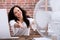 Woman Cooling Herself In Front Of Fan