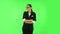 Woman coquettishly smiling while looking at camera. Green screen