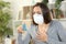 Woman with coronavirus symptoms holding inhaler at home
