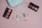 Woman cosmetic bag, make up beauty products on pink background. Makeup brushes and rouge palettes. Decorative cosmetics. Top view,