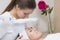 Woman and cosmetician during facial spa procedure in the beauty