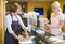 Woman at counter in restaurant serving customer