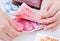 Woman counting Chinese yuan banknotes