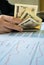 Woman is counting money with statement paper financial concept.