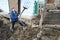 A woman in the countryside chooses manure from the pit early spring to the city