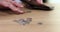 Woman counts money coins on table closeup