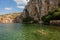 Woman  covered with fish peeling at the Voulagmeni thermal lake, Greece